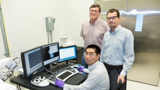 ORNL’s Yang Song (seated), Dale Hensley (standing left) and Adam Rondinone