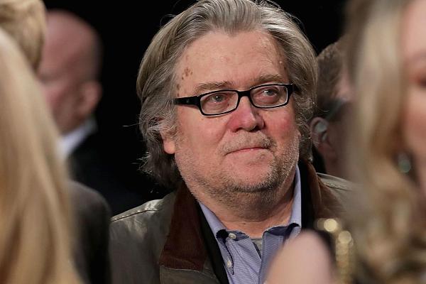 Republican presidential nominee Donald Trump's campaign CEO Steve Bannon (C) listens to Trump speak during his final campaign rally on Election Day in the Devos Place November 8, 2016 in Grand Rapids, Michigan.