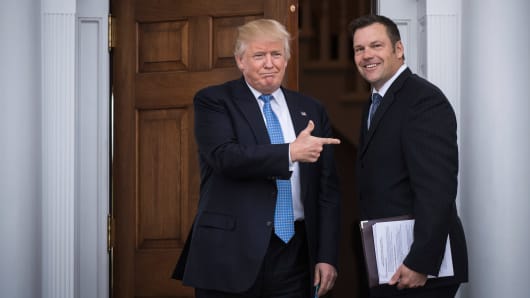 President-elect Donald Trump greets Kansas Secretary of State, Kris Kobach, at the clubhouse at Trump National Golf Club Bedminster in Bedminster Township, N.J. on Sunday, Nov. 20, 2016.