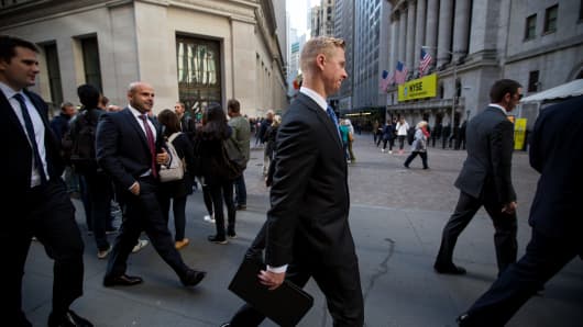 Pedestrians walk past the New York Stock Exchange (NYSE) in New York.