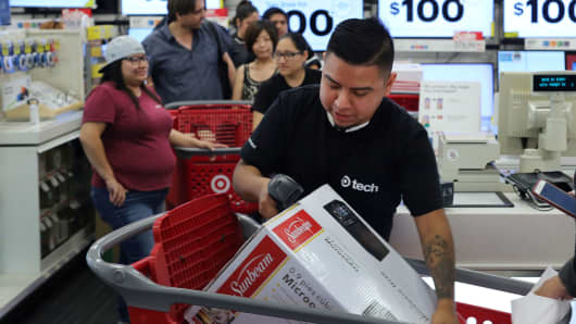 An employee scans a purchase during Black Friday sales at a Target store in Culver City, California, November 25, 2016.