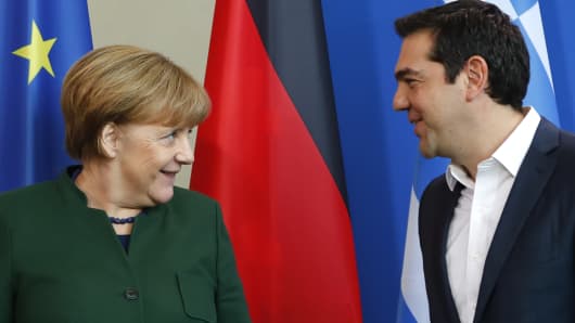 German Chancellor Angela Merkel and Greek Prime Minister Alexis Tsipras leave after a statement at the chancellery in Berlin on Dec. 16, 2016.