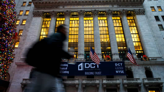 A pedestrian passes the New York Stock Exchange.