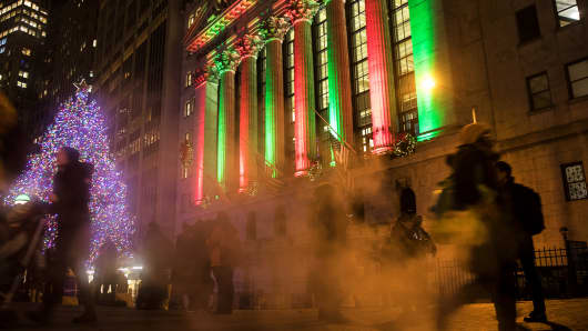Pedestrians pass by the New York Stock Exchange.
