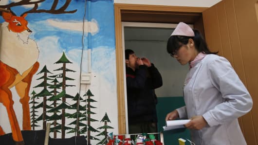 A nurse distributes medicine at Daxing Internet Addiction Treatment Center in Beijing.