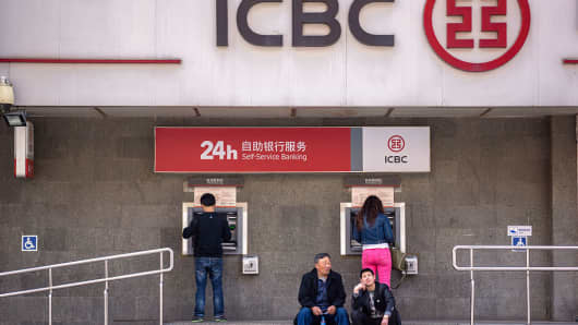 People withdraw money from an ICBC branch in Beijing.