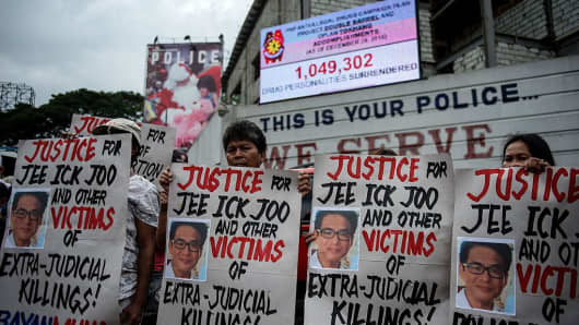 Activists hold a protest in front of Camp Crame, the headquarters of the Philippine National Police (PNP), hold placards showing the picture of the late South Korean businessman Jee Ick-Joo, who was murdered allegedly by suspected policemen in Manila on January 27, 2017.