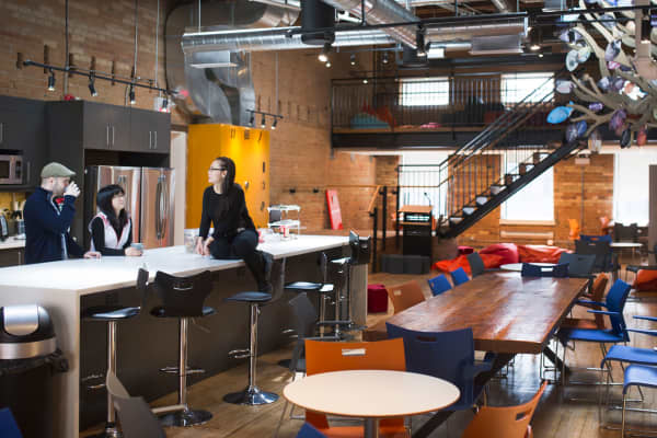 Employees of Wattpad Technology meet in their company's kitchen space in Toronto, Ontario, Canada.