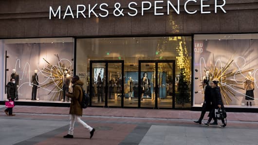 Pedestrians walk past the Marks & Spencer flagship store on December 21, 2015 in Beijing, China. The retailer has since exited the Chinese market.