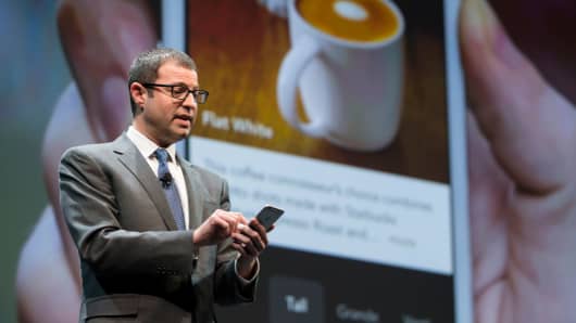 Starbucks' Adam Brotman demonstrates mobile order and pay on the the company's app during the Starbucks annual shareholders meeting.