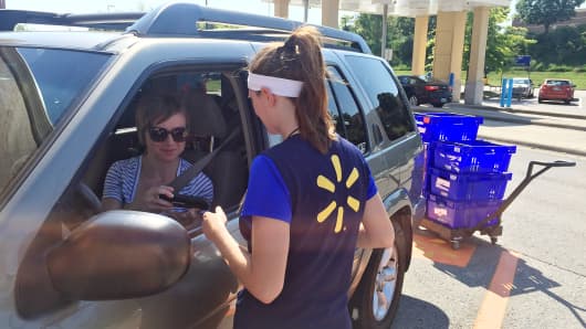 Ashley Green, 31, talks to a Walmart personal shopper as she retrieves her online grocery pickup order at the chain's Franklin, Tenn., location.