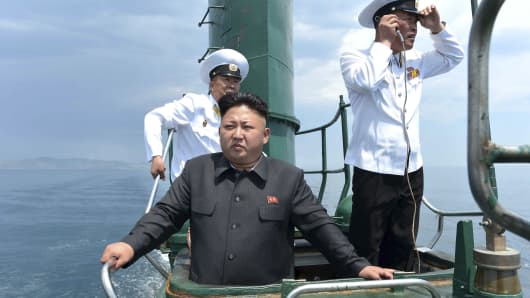 North Korean leader Kim Jong Un (front) stands on the conning tower of a submarine during his inspection of the Korean People's Army (KPA) Naval Unit 167 in this undated photo released by North Korea's Korean Central News Agency (KCNA) in Pyongyang.