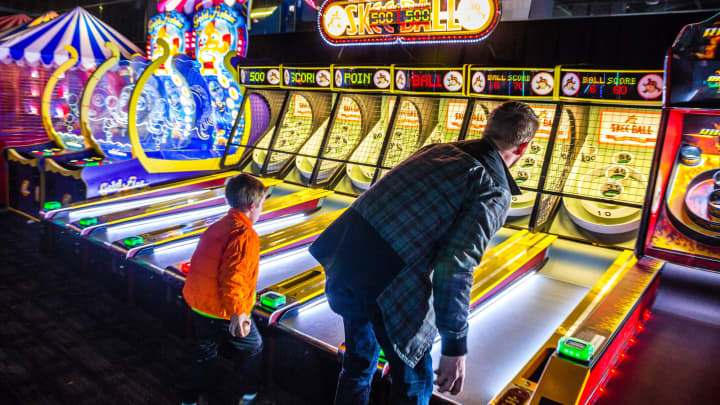 Customers play skee ball at a Dave & Buster's Entertainment location in Pelham, New York.