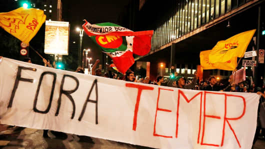 Demonstrators protest against Brazil's President Michel Temer in Sao Paulo, Brazil, May 17, 2017. The banner reads: "Out Temer."