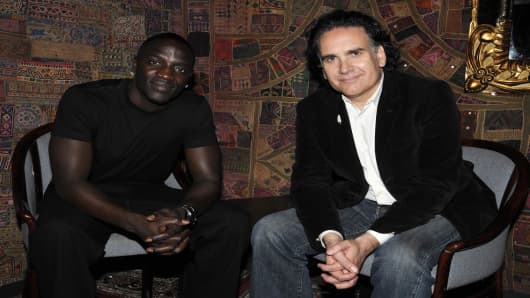 Musicians Akon and Peter Buffett pose for a photograph as they announce a socially conscious musical collaboration and website.