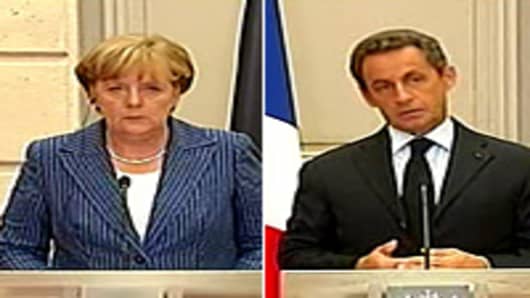 German Chancellor Angela Merkel and France's President Nicolas Sarkozy speak at a meeting on debt crisis.