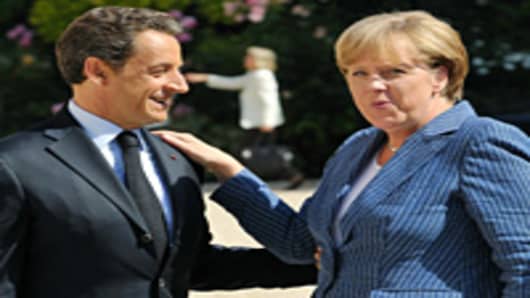 France's President Nicolas Sarkozy (L) welcomes German Chancellor Angela Merkel as she arrives for a meeting on debt crisis on August 16, 2011 at the Elysee presidential palace in Paris.