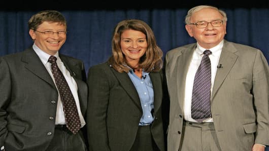 Bill Gates, left, Melinda Gates and Warren Buffett pose for a picture after a press conference Monday, June 26, 2006 in New York.  Warren Buffett, the chairman of Berkshire Hathaway, recently announced his intention of giving 10 million shares of his company to charitable organizations, the majority going to the Bill and Melinda Gates Foundation.  (AP Photo/Seth Wenig)