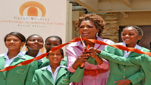 U.S. talk show queen Oprah Winfrey and learners cut the ribbon at the official opening of her Leadership Academy for Girls School at Henley-on-Klip, South Africa, Tuesday, Jan. 2, 2007. Winfrey opened the world class school for poor but talented South African girls fulfilling a long-cherished dream and a promise to her hero, Nelson Mandela.  (AP Photo/Denis Farell)