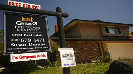 A reduced sale sign tops an advertisement for an exisiting home in Los Angeles Wednesday August 23, 2006. Sales of previously owned homes plunged in July to the lowest level in 2 1/2 years and the inventory of unsold homes climbed to a new record high, fresh signs that the housing market has lost steam. (AP Photo/Oscar Hidalgo)