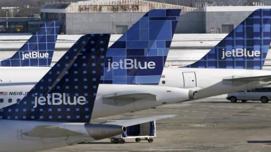 JetBlue planes wait at terminal gates at JFK Airport in New York, Friday, Feb. 16, 2007. JetBlue travelers continued to experience delays and cancellations Friday as the airline struggled for a third day to recover from an operational meltdown at John F. Kennedy International Airport. (AP Photos/Bebeto Matthews)
