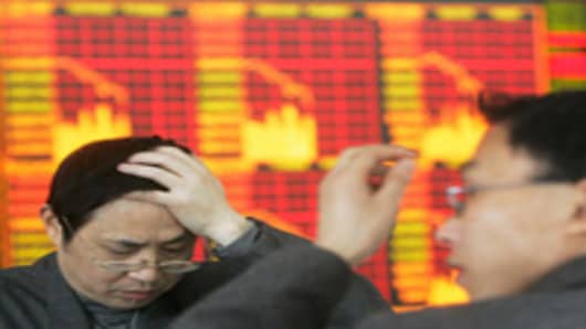 Stock investors watch stock movement at a stock exchange in Chengdu, China.