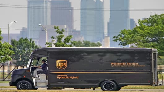 A hydraulic hybrid UPS delivery truck is seen with the Philadelphia skyline in the background during a demonstration in Philadelphia, on Friday, June 23, 2006.  The UPS truck uses an Environmental Protection Agency patented hydraulic hybrid technology that the EPA claims will increase fuel efficiency by 60 to 70 percent.  Full hydraulic hybrid technology means that the conventional transmission and transfer case have been removed and replaced with a hydraulic drivetrain. (AP Photo/Matt Rourke)