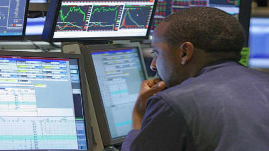 A specialist is surrounded by screens as he works at his post on the floor of the New York Stock Exchange, Tuesday, June 5, 2007. Stocks dipped Tuesday after comments from Federal Reserve Chairman Ben Bernanke and a strong reading on the U.S. service sector suggested the central bank has little reason to lower interest rates.