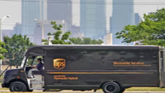 A hydraulic hybrid UPS delivery truck is seen with the Philadelphia skyline in the background during a demonstration in Philadelphia, on Friday, June 23, 2006. The UPS truck uses an Environmental Protection Agency patented hydraulic hybrid technology that the EPA claims will increase fuel efficiency by 60 to 70 percent. Full hydraulic hybrid technology means that the conventional transmission and transfer case have been removed and replaced with a hydraulic drivetrain. (AP Photo/Matt Rourke)