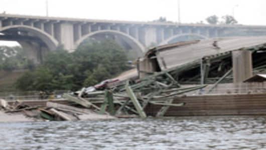 Wreckage lies in the water at the scene of a freeway bridge collapse over the Mississippi River in Minneapolis Wednesday, Aug. 1, 2007. The entire span of the 35W bridge collapsed about 6:05 p.m. where the freeway crosses the river near University Avenue. (AP Photo/Erik S. Steinmetz)