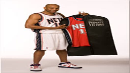 Nets guard Vince Carter with the garment bag.