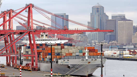 A container ship from Korea sits at a loading dock at Seattle's Harbor Island near downtown, Thursday, May 11, 2006. The U.S. trade deficit unexpectedly declined in March for a second consecutive month, something that hasn't happened in more than two years. The improvement reflected record U.S. exports and a big drop in the country's foreign oil bill. (AP Photo/Elaine Thompson)