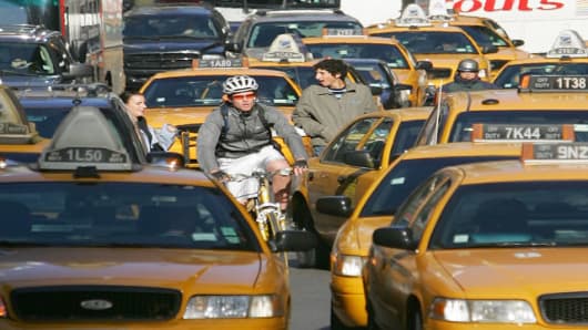 A cyclist navigates the street jammed by traffic in New York's Times Square Saturday, Nov. 19, 2005. With a month left in the year, police records show 21 cyclists have died in traffic accidents in New York, up from 15 in all of 2004. (AP Photo/ Dima Gavrysh)