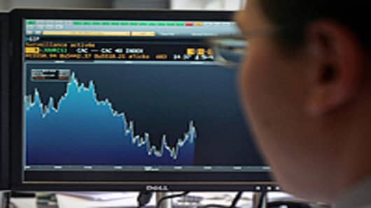 A broker works as his control screen shows a graph of activity on the French Stock Exchange in Paris.