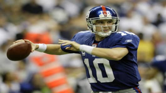 New York Giants quarterback Eli Manning (10)passes against the Dallas Cowboys in their NFL football game, in this Sept. 9, 2007 photo, in Irving Texas.  Manning was at practice Wednesday, Sept. 12, 2007, taking snaps and handing off as he tested his bruised right shoulder. (AP Photo/Matt Slocum)