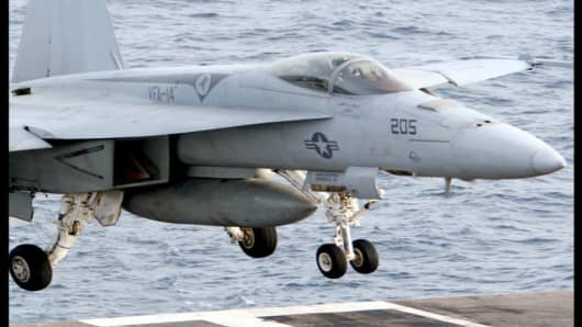 An American F-18 aircraft lands onboard the USS Nimitz on Monday, June 4, 2007, in the Persian Gulf, where the Nimitz and the USS John C. Stennis aircraft carrier groups are on patrol. The United States has its largest naval force in the region since just before the 2003 invasion of Iraq as concern grows it could attack Iran over the Persian nation's nuclear program. (AP Photo/Hasan Jamali)