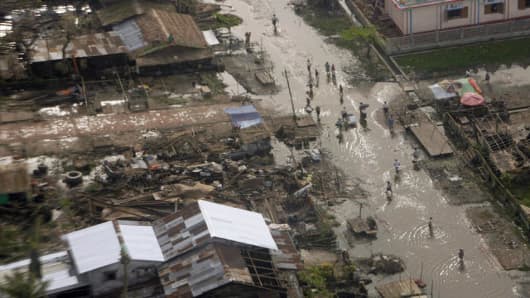 A village damaged by Cyclone Nargis is seen Thursday, May 22, 2008 in an aerial view over the Irrawaddy delta, Myanmar from the helicopter carrying United Nations Secretary General Ban Ki-Moon. (AP Photo/United Nations, Evan Schneider)