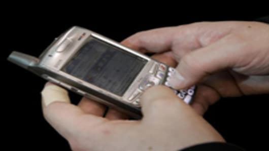 A person uses a Palm Treo.