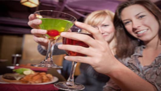 Women drinking cocktails at a club.