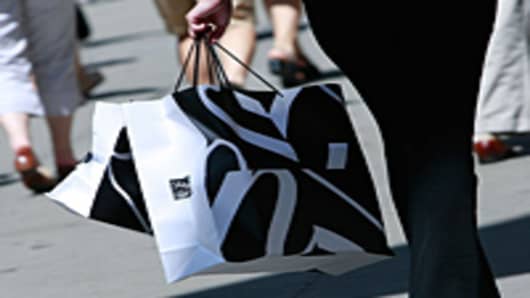 A shopper carries Saks Fifth Avenue bags up Fifth Avenue in New York City.