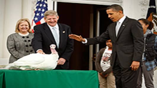 U.S. President Barack Obama pardons a turkey named 'Courage' as daughter Sasha (2nd R) looks on during an event to pardon the 20-week-old and 45-pound turkey at the North Portico of the White House.