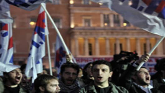 Demonstrators shout slogans against government's recent austerity economy measures during a protest in Athens.