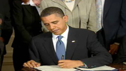 President Obama signs the health care reform bill into law at the White House