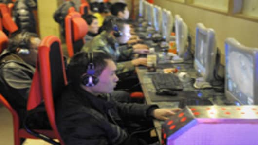 Young men play online games at an internet cafe in Beijing.