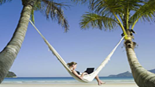 Woman in hammock using laptop