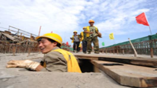 Workers assist at a construction site of the Chengdu-Dujiangyan railway.