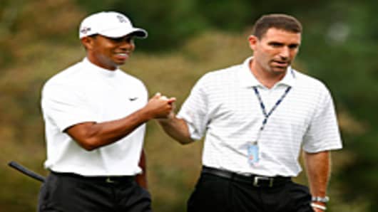 Tiger Woods walks alongside his manager Mark Steinberg of IMG during a practice round prior to the start of THE TOUR Championship at East Lake Golf Club in Atlanta, Georgia.