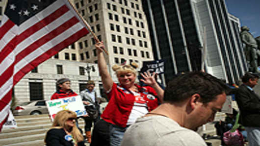 A participant waves an American flag at a Tea Party Express rally in Albany, New York.