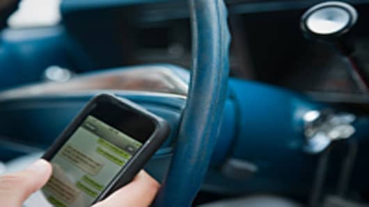 Person text messaging while driving