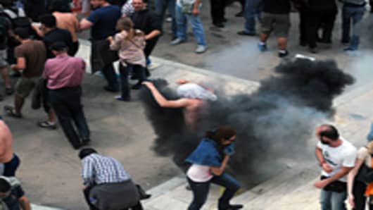 Greek riot policemen clash with protestors in the center of Athens on May 5, 2010.